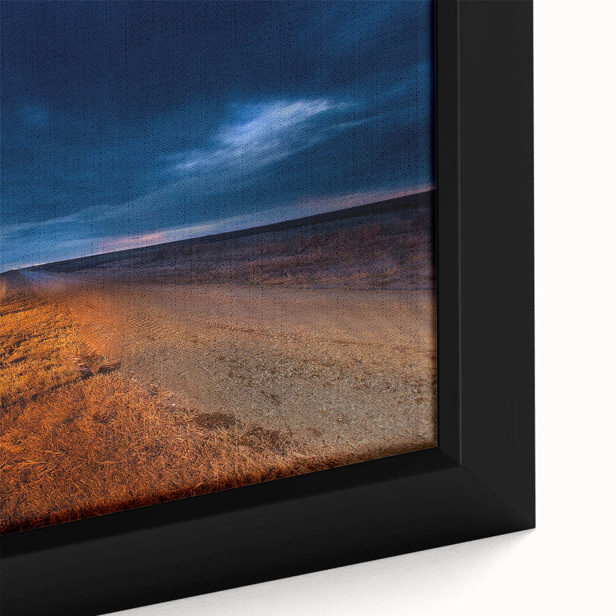 Close-up of textured black wall art depicting a North Dakota landscape on a framed canvas, featuring colorful accents.
