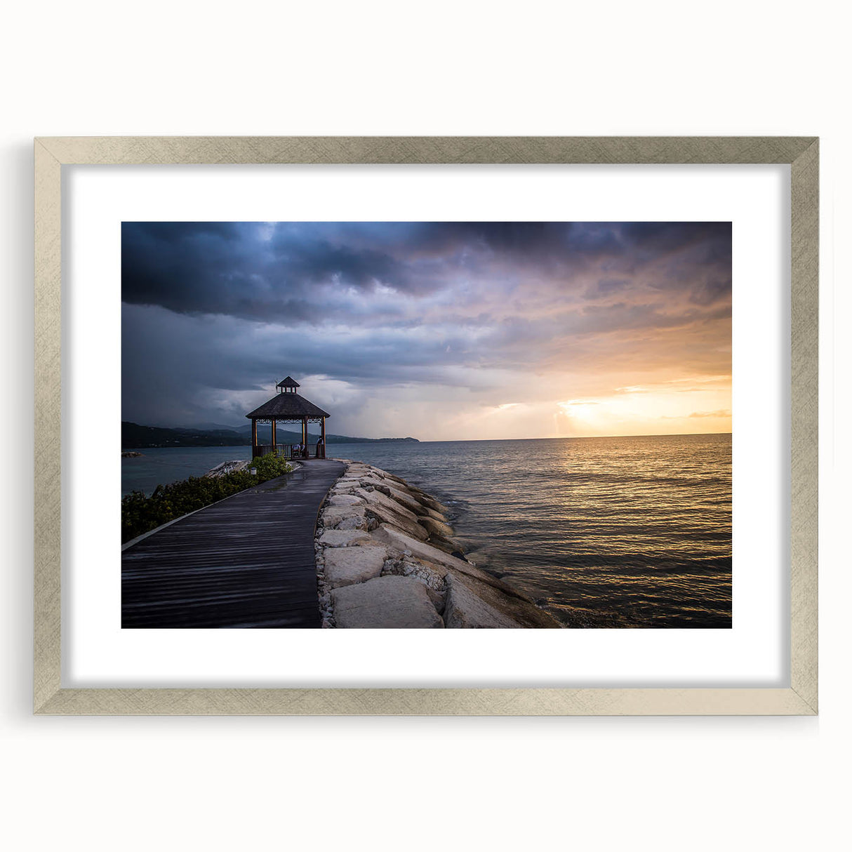 Extra large abstract art print depicting a Caribbean scenery in textured blues and greens, framed in silver.