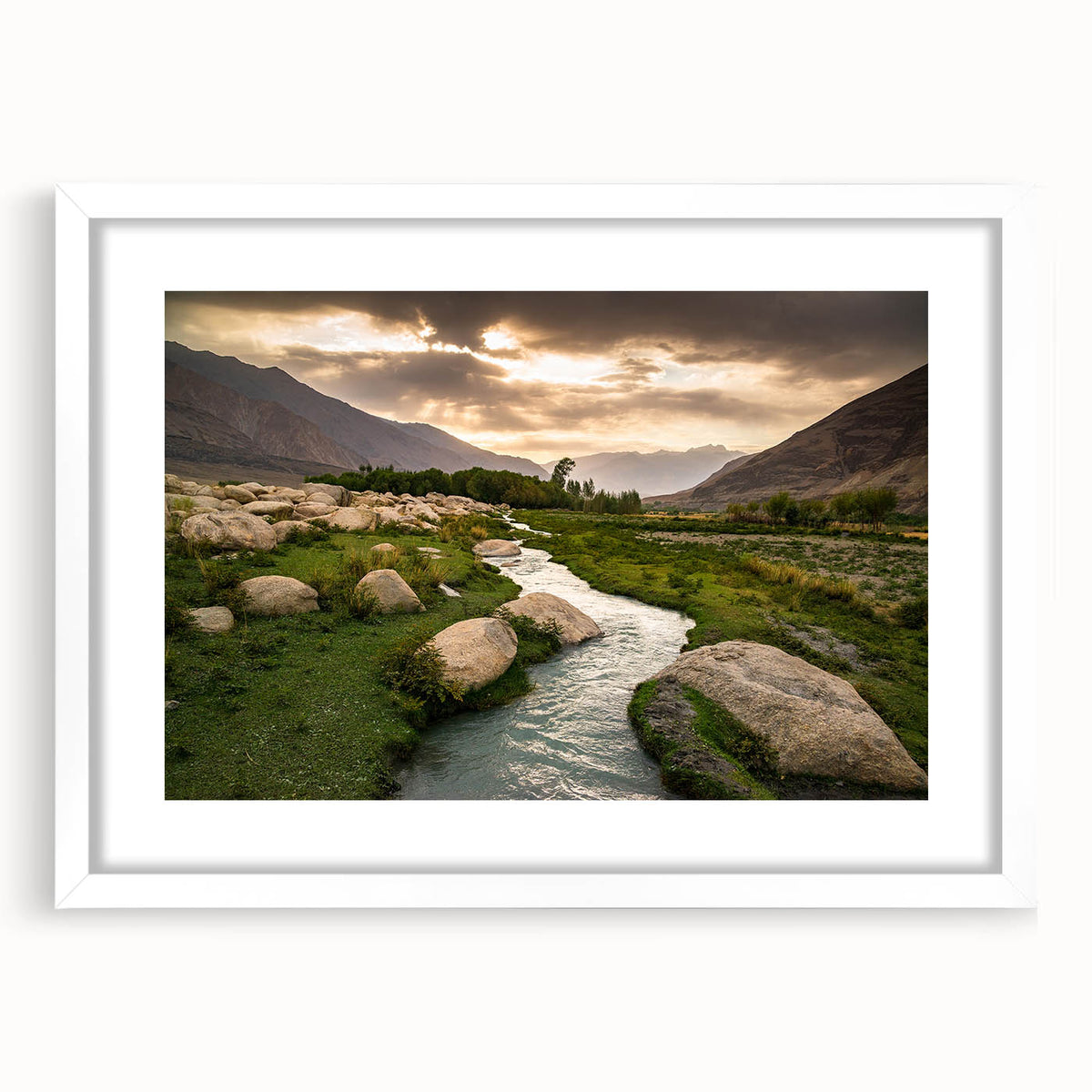 Abstract art print featuring muted earth tones of a Middle Eastern landscape on a framed white mat.