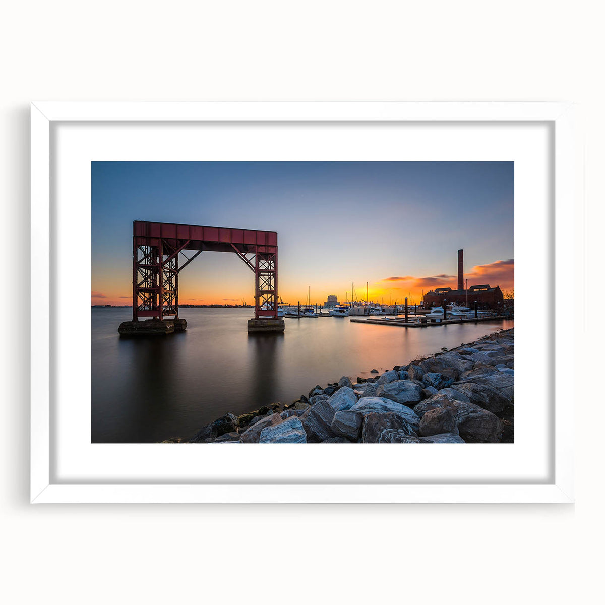 Abstract art print of Baltimore skyline in muted blue and gray tones on a framed white mat, ideal for dining room decor.