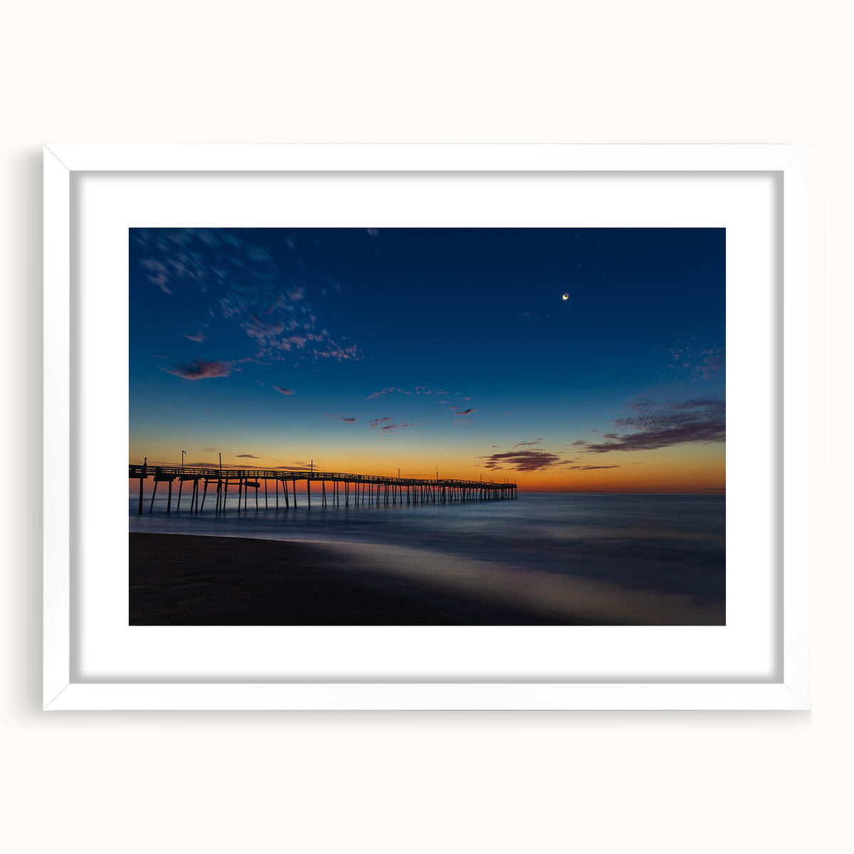 Abstract art print of Cape Hatteras with muted blue and green tones on a white framed canvas, suitable for dining room decor.