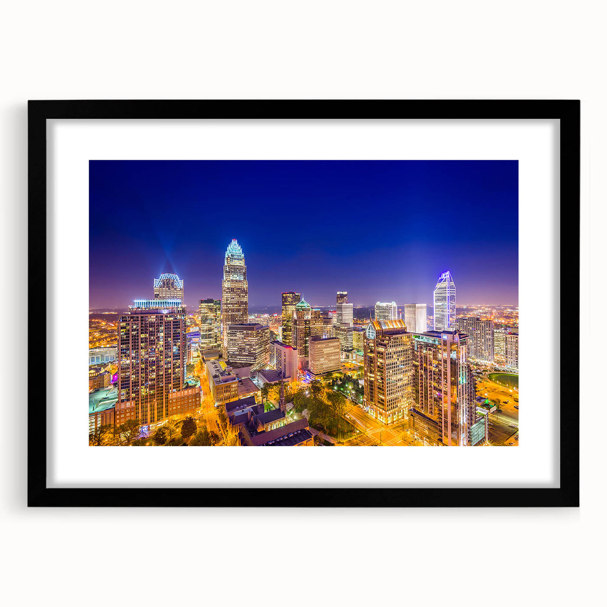 Abstract art print of Charlotte skyline with vibrant colors on a large framed canvas, suitable for living room decor.