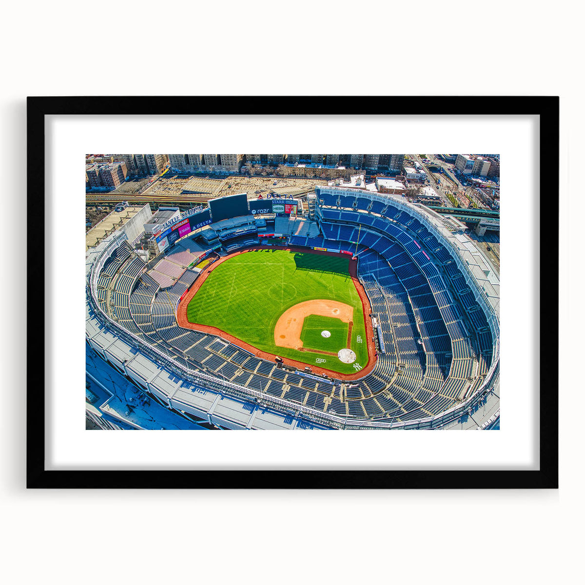 Extra large abstract art print of New York City in vibrant colors on a textured canvas, framed in black.
