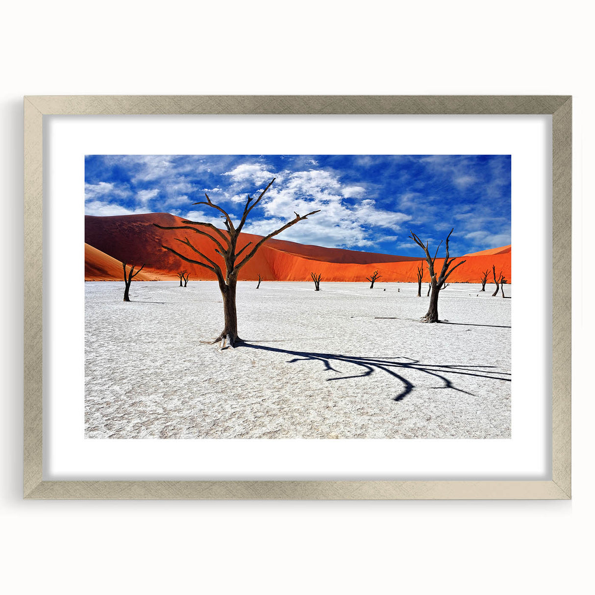 Abstract art print of African scenery in muted earth tones on a framed silver mat, suitable for dining room or bedroom decor.