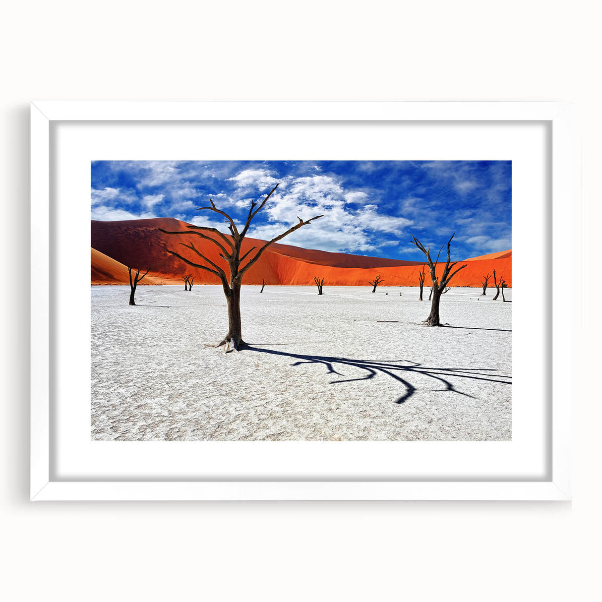 Extra large abstract art print of African scenery in textured style, featuring muted earth tones, framed in white.
