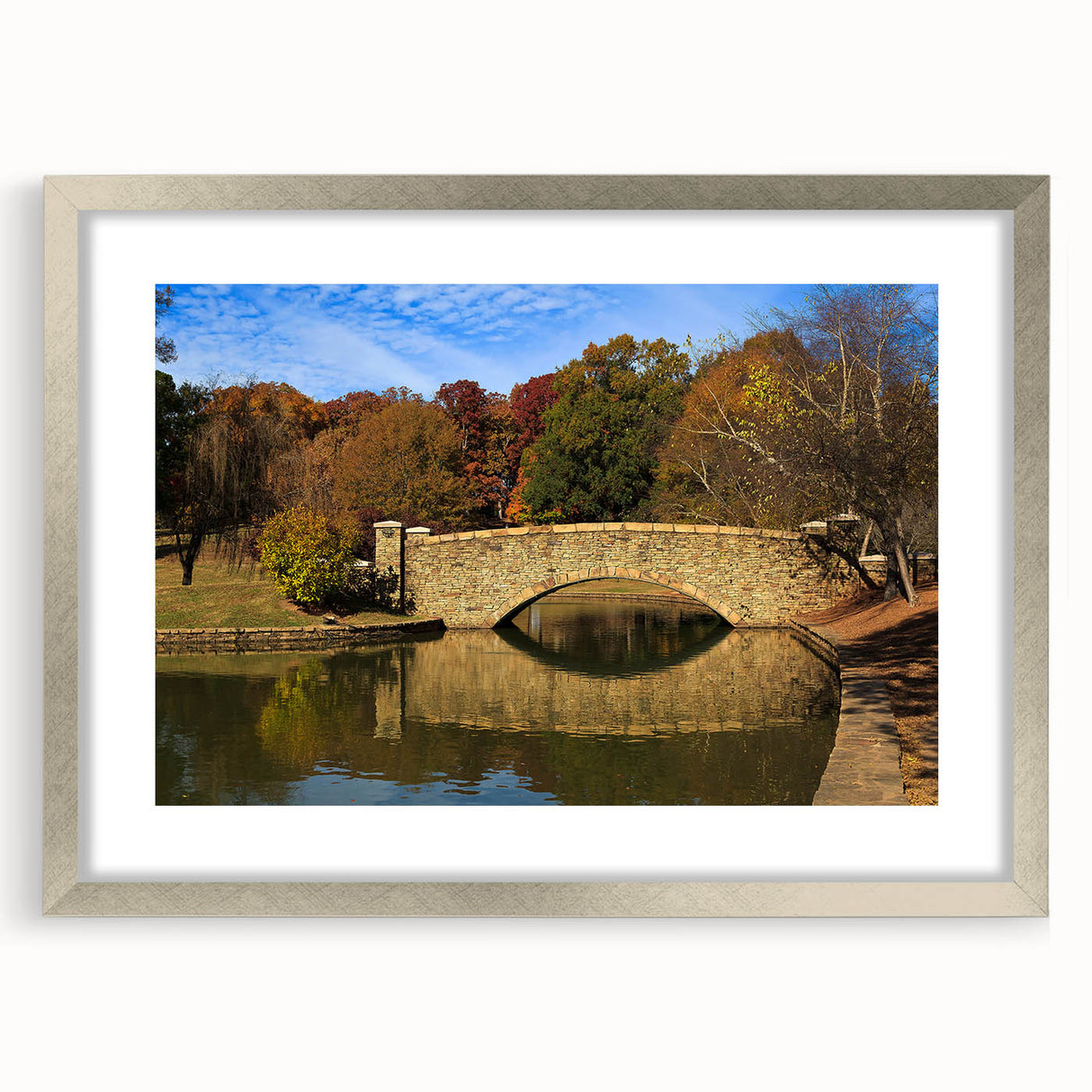 Textured abstract art print of Charlotte skyline in muted blue and gray, framed in silver, ideal for bedroom decor.