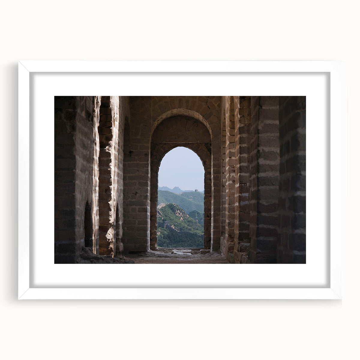 Abstract art print of the Great Wall of China in muted earth tones, framed in white, ideal for dining room decor.