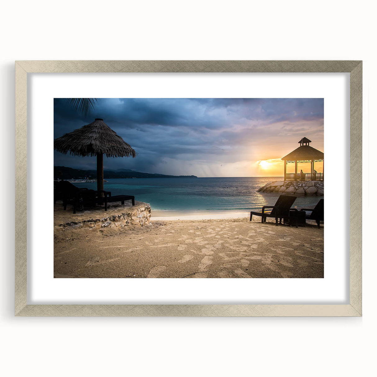 Extra large abstract art print depicting a Caribbean scenery in vibrant blues and greens, framed in silver.
