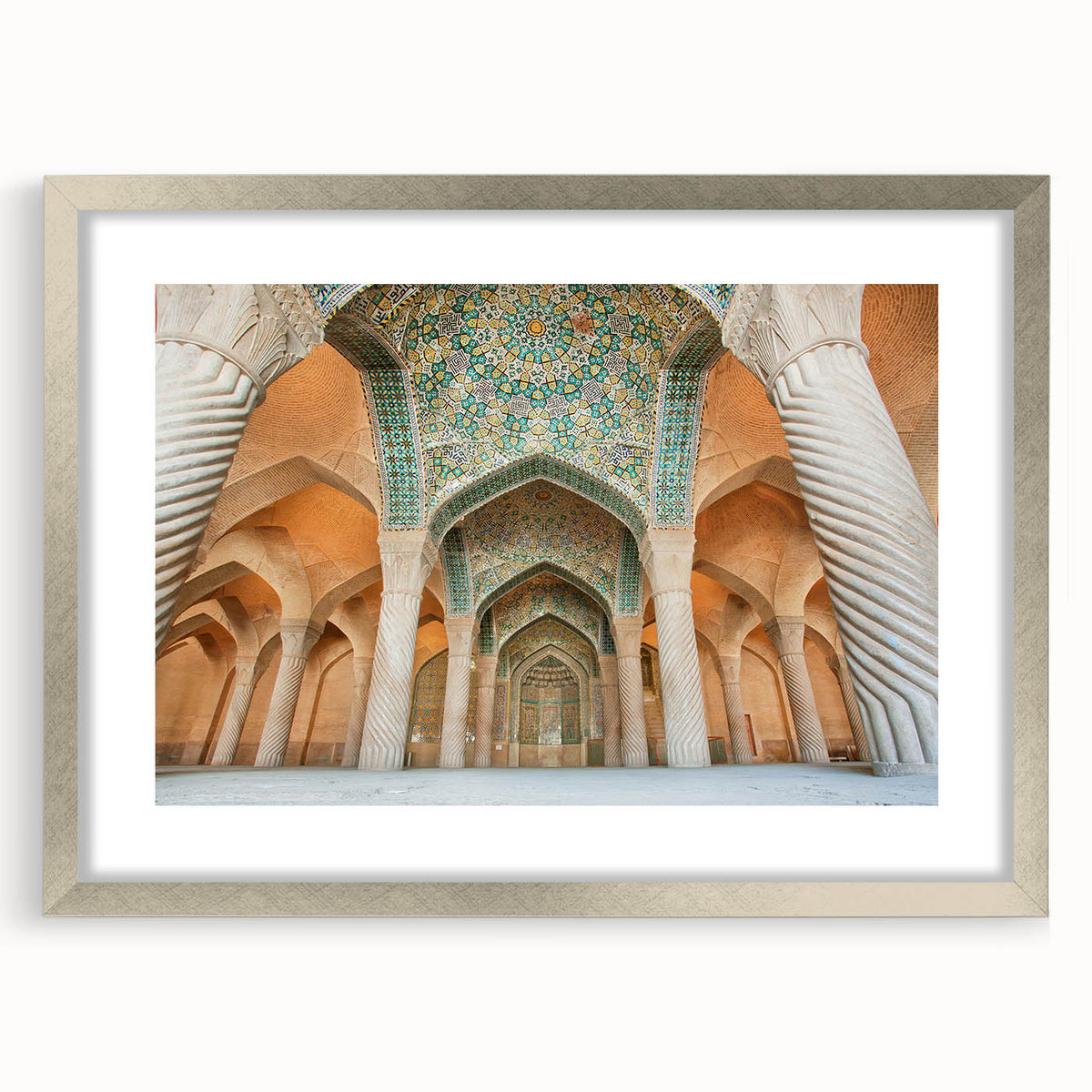 Textured art depicting abstract Middle Eastern scenery in muted earth tones on a framed silver mat.