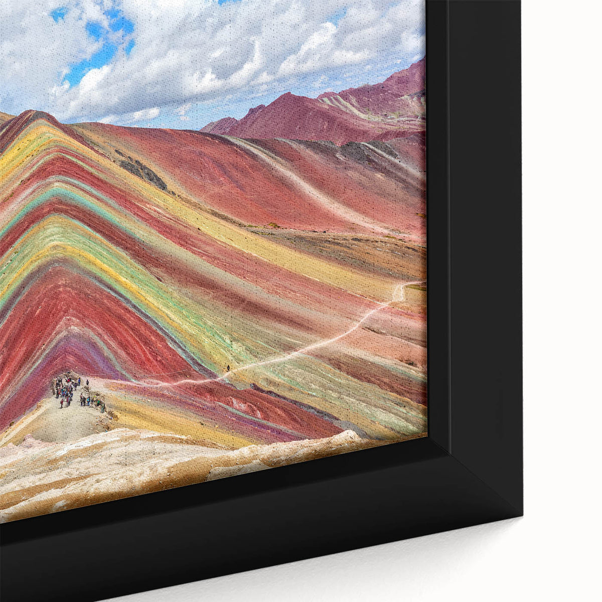 Close-up of a framed canvas featuring a textured, colorful depiction of a South American scenery.