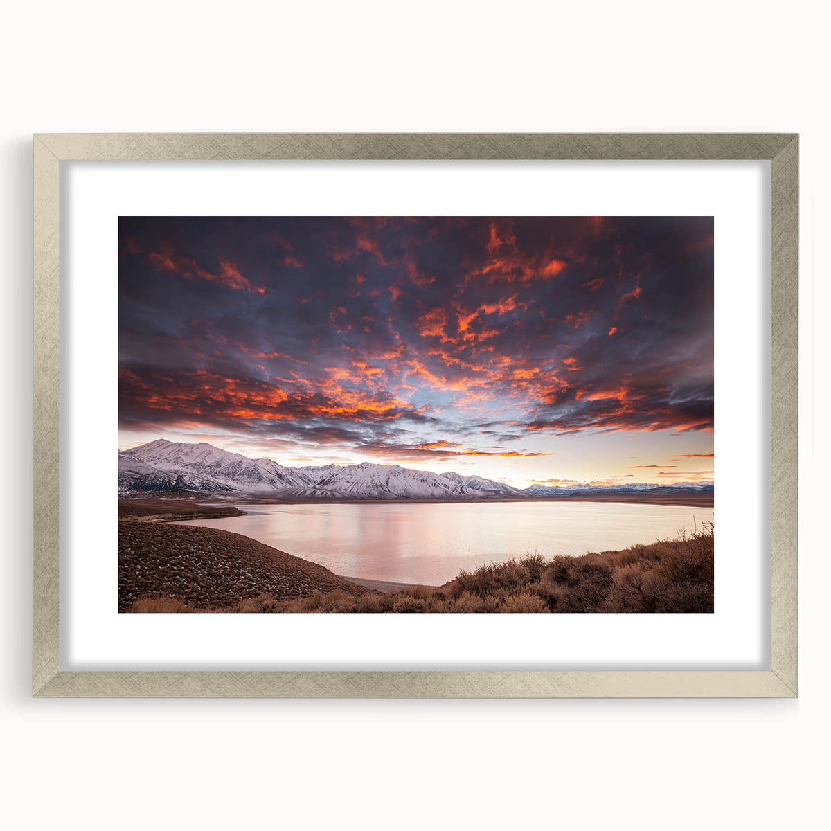 Textured abstract art print of Sierra Nevada in muted earth tones on a silver-framed mat, suitable for bedroom decor.