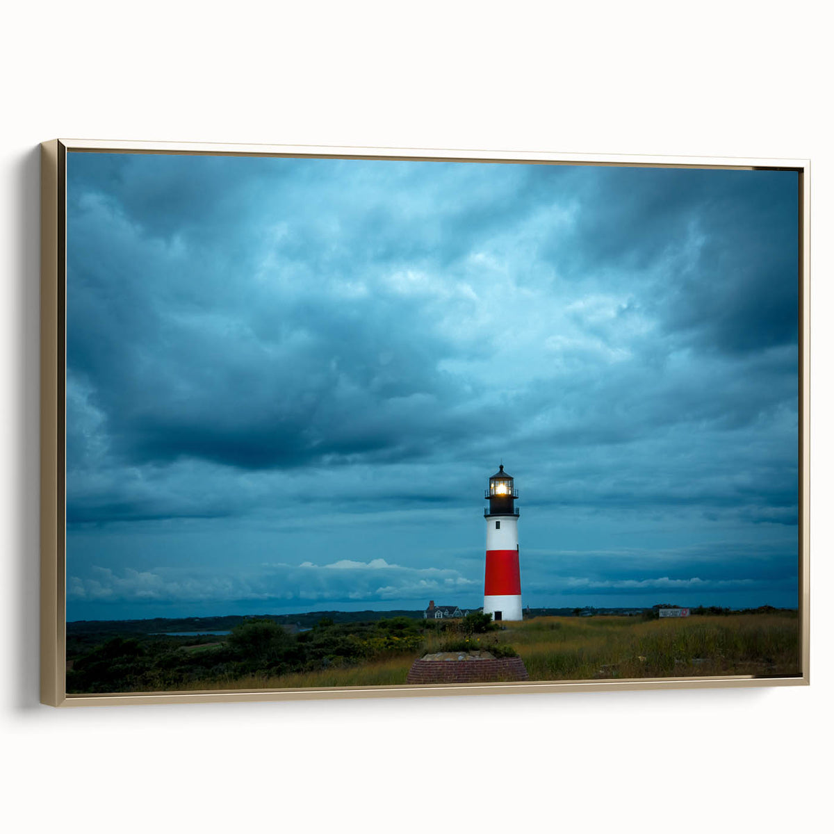 Framed canvas depicting a vintage-style landscape painting of Nantucket, featuring muted earth tones.