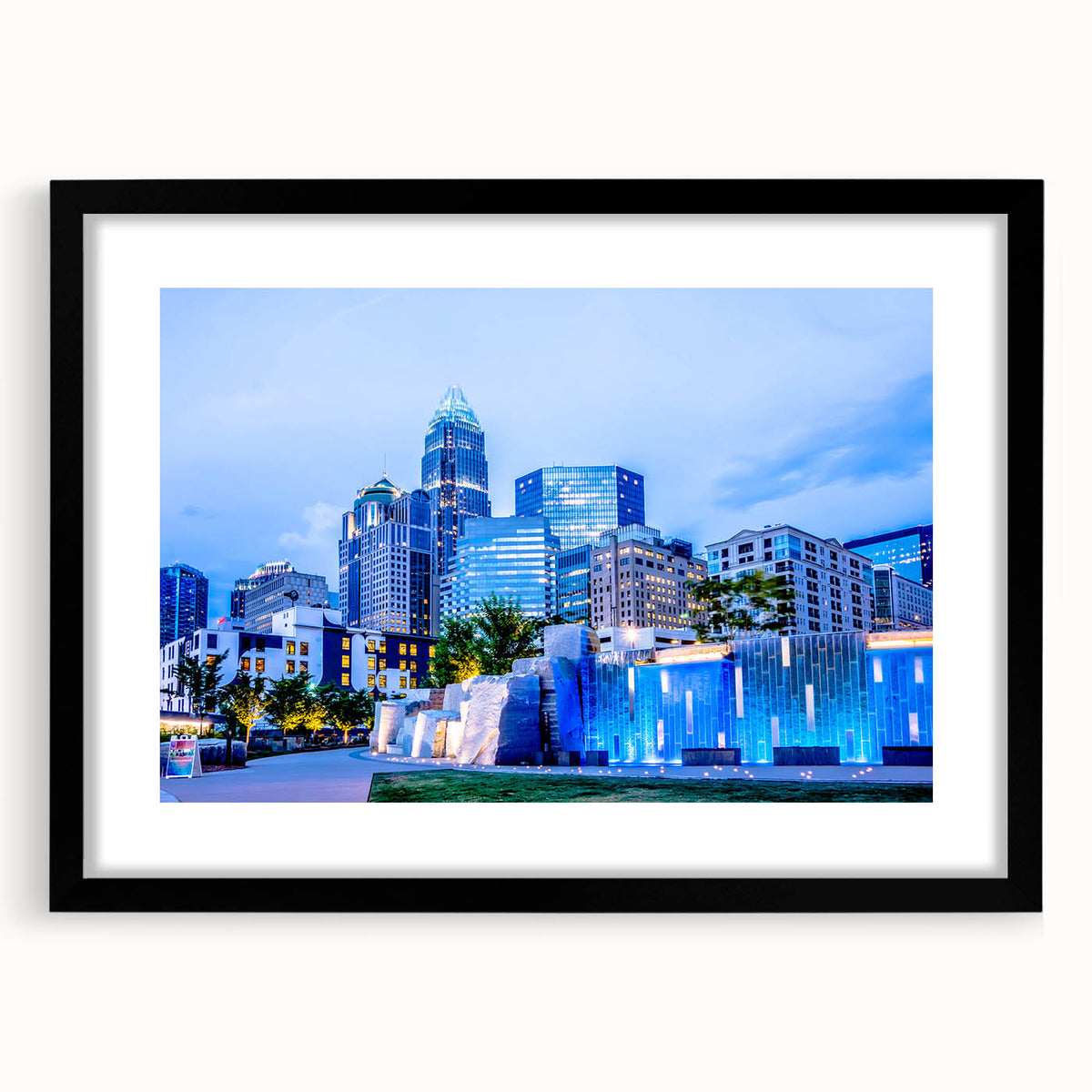 Abstract art print of Charlotte skyline in vibrant, colorful hues on a large framed canvas, ideal for living room decor.