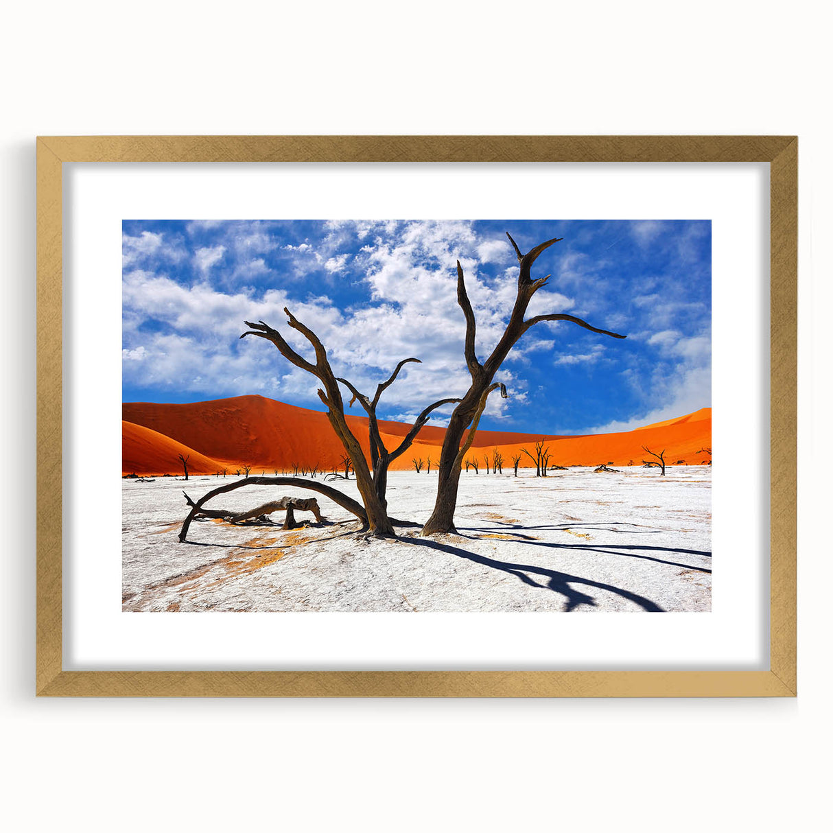 Textured abstract art print of an African landscape in muted earth tones, framed in gold, suitable for bedroom decor.