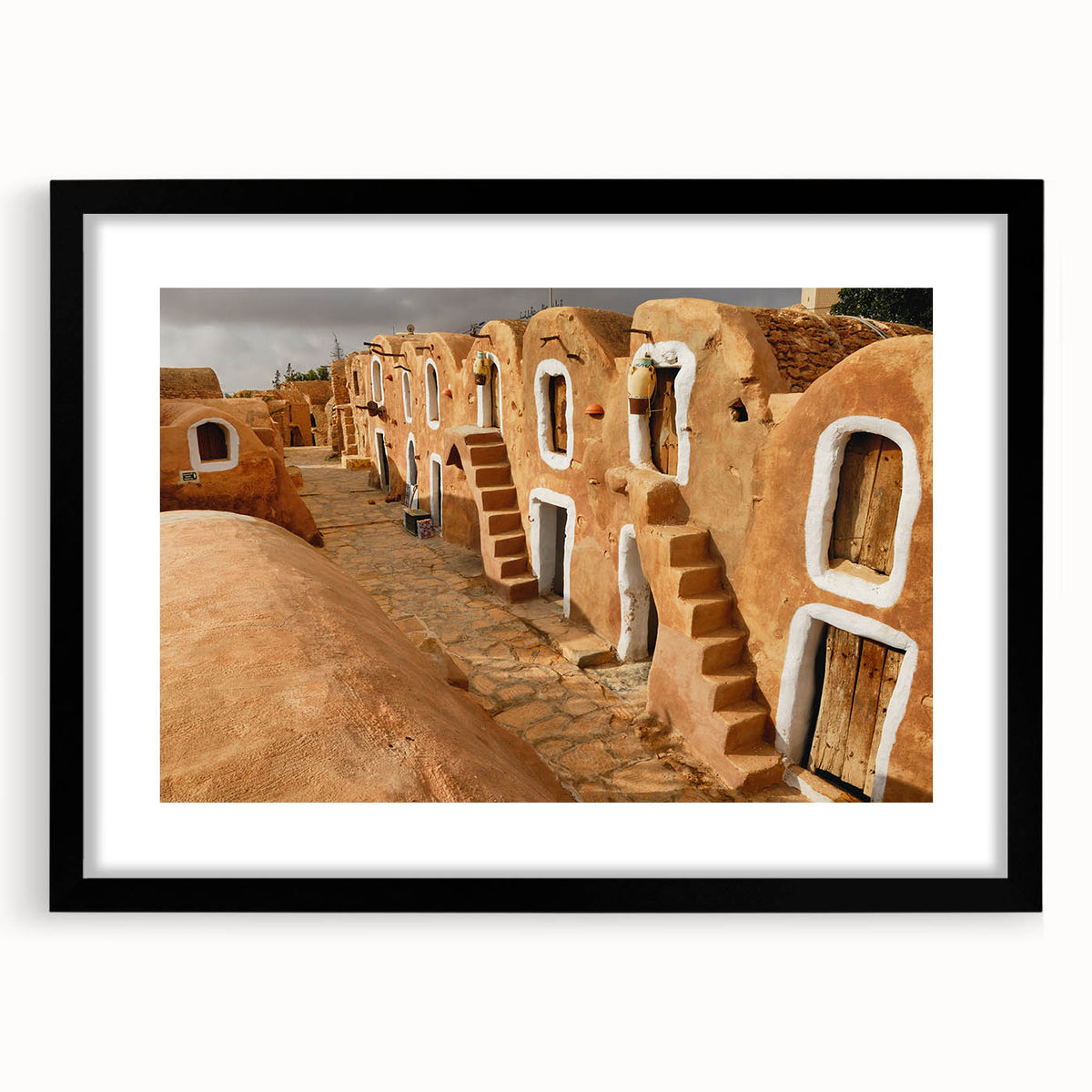 Abstract art print of a vibrant, colorful African scenery on a large textured canvas, framed in black.