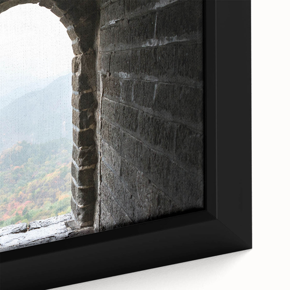 Close-up of a black framed canvas featuring a textured depiction of the Great Wall of China in vibrant colors.
