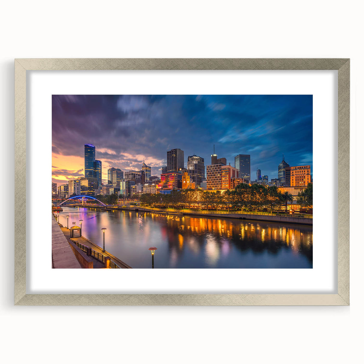 Abstract art print of Melbourne scenery in muted blue and gray tones, framed in silver, suitable for dining room decor.