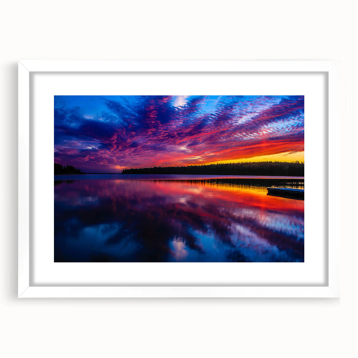 Abstract art print depicting a serene Manitoba landscape in cool blues and greens, framed in white.