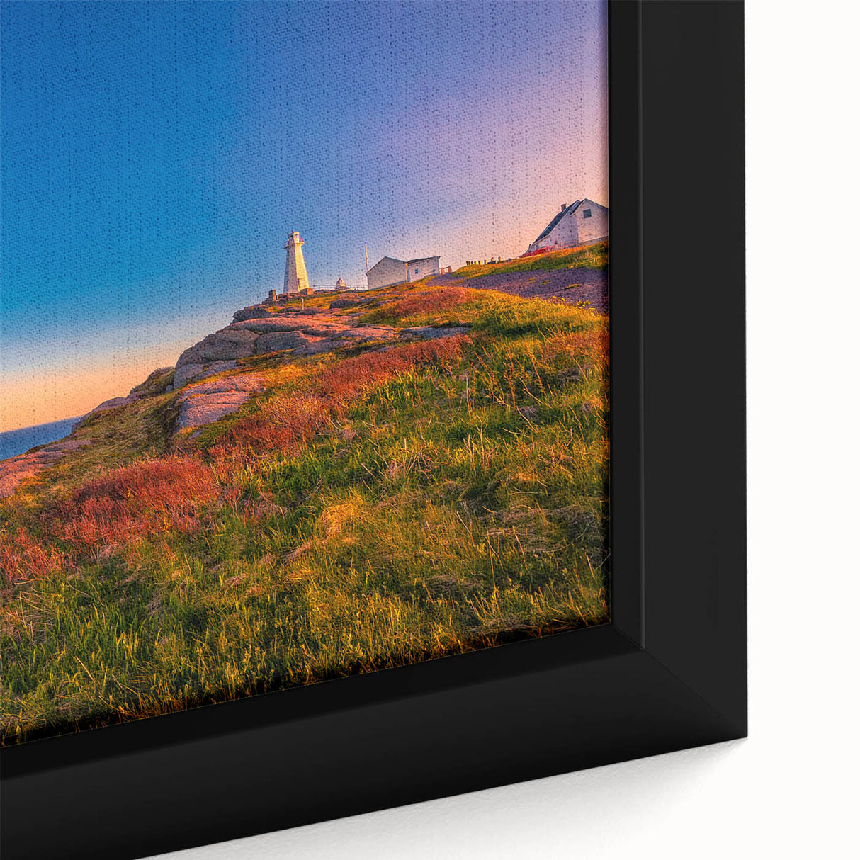 Close-up of a textured black wall art depicting Newfoundland scenery on a framed canvas, with vibrant color accents.