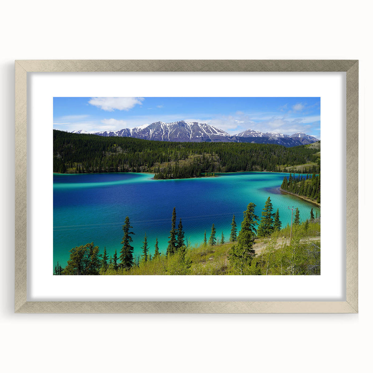 Textured abstract art print of a Yukon scenery in muted earth tones, framed in silver, suitable for bedroom decor.