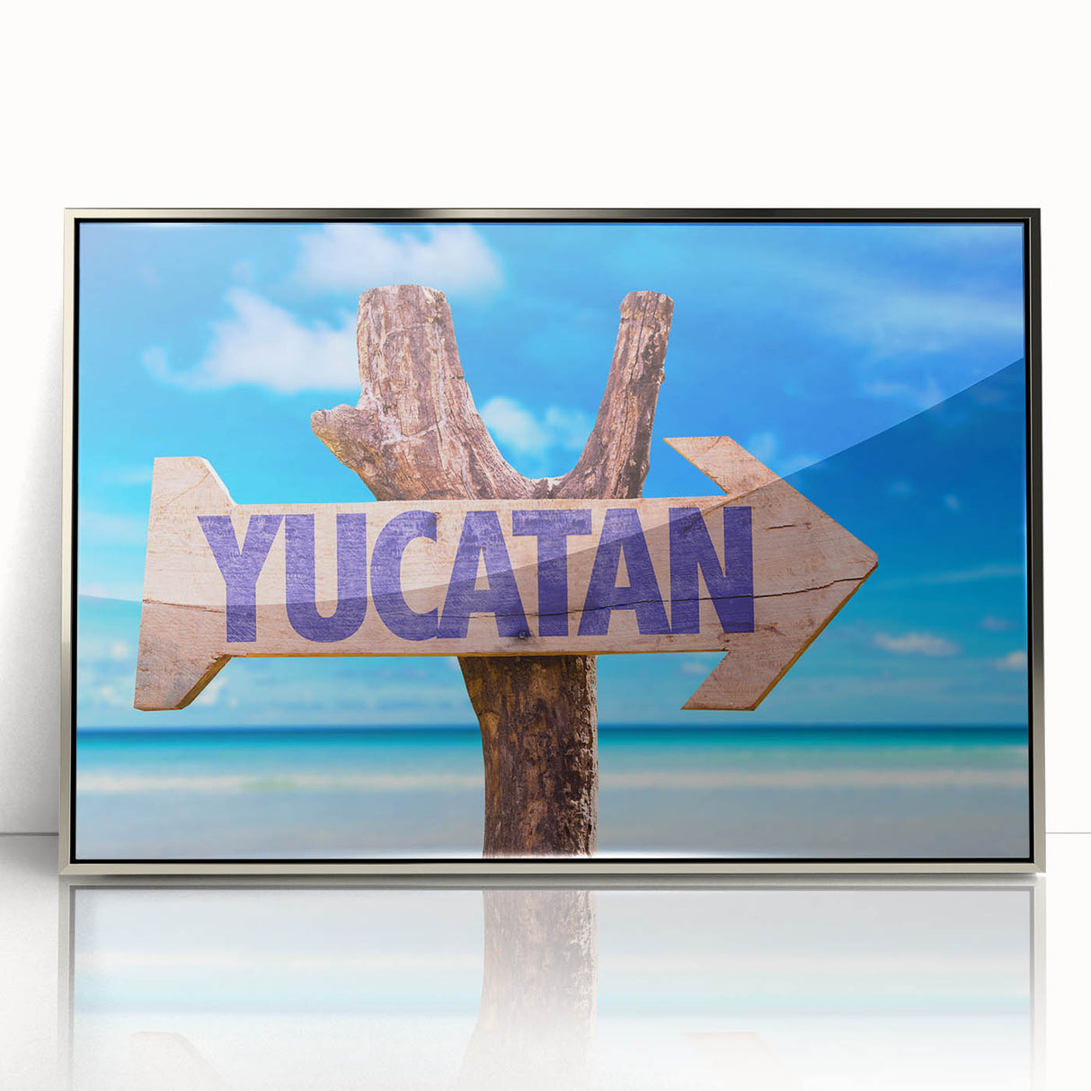 Mid-century modernist art depicting Yucatan scenery in muted greens and blues on a silver-framed acrylic.