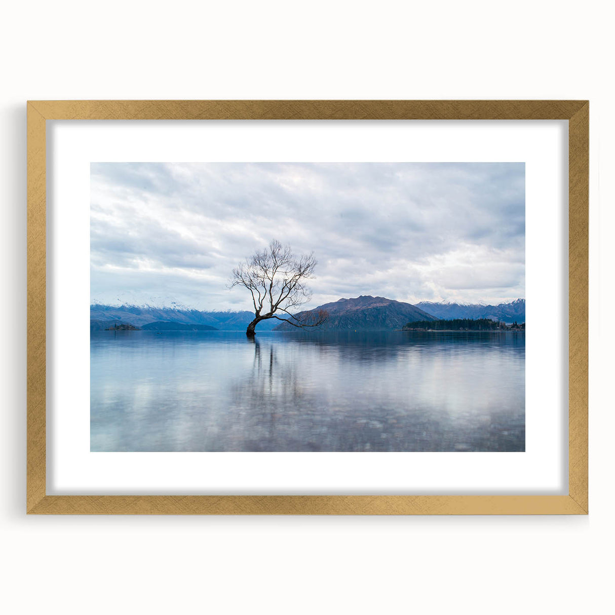 Extra large abstract art print of Otago, New Zealand scenery in gold frame, featuring textured blue and green tones.