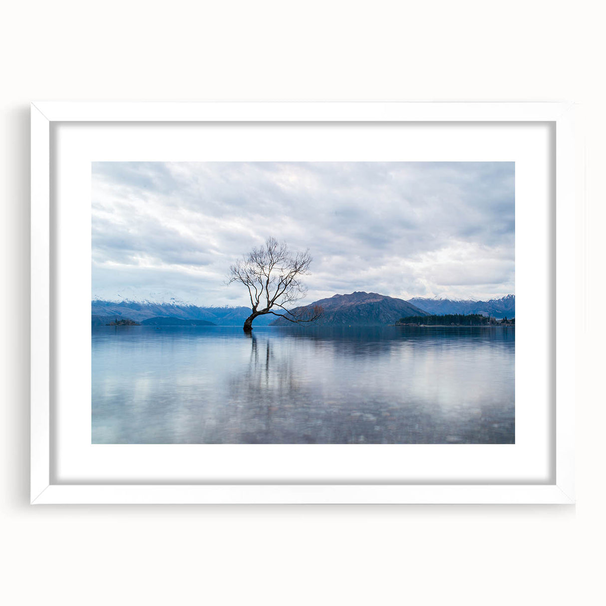 Abstract art print of Otago, New Zealand, with vibrant blue and green tones, framed in white, ideal for dining room decor.