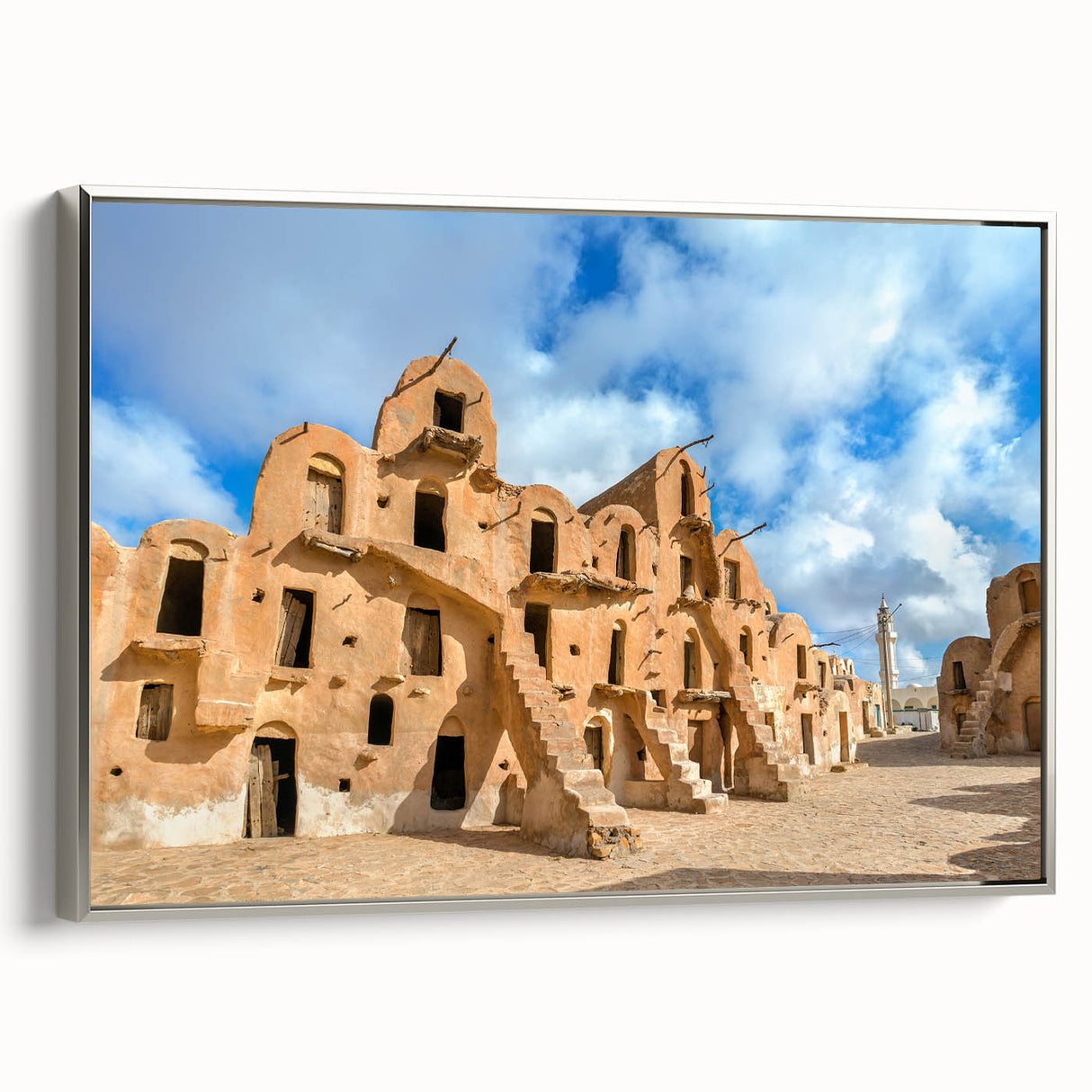 Framed canvas landscape art painting of a Tunisian scenery in muted earth tones.