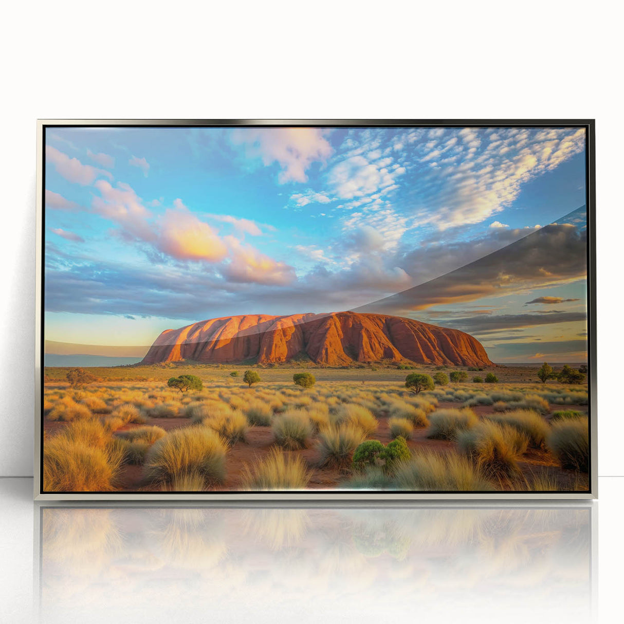Acrylic print of Ayers Rock in Australia, with muted earth tones, framed in silver, suitable for modern art wall decor.