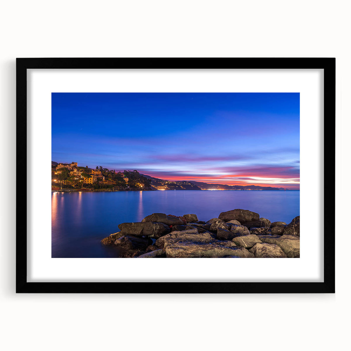 Colorful abstract art print of Portofino, Italy in vibrant hues on a large black-framed canvas, ideal for living room decor.