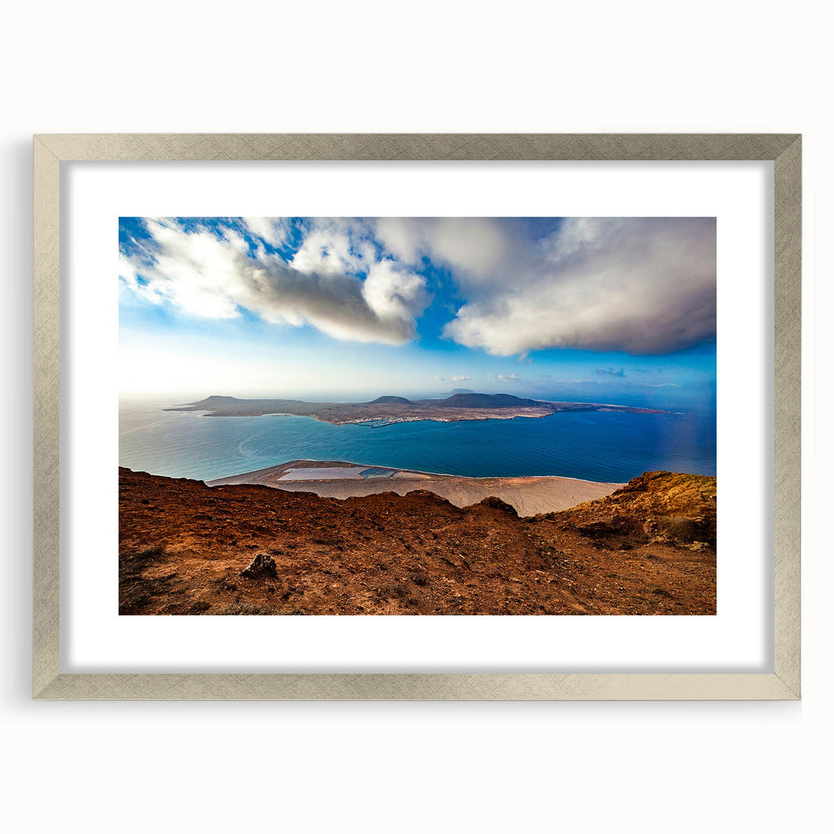 Extra large abstract art print depicting a textured European scenery in muted earth tones, framed in silver.