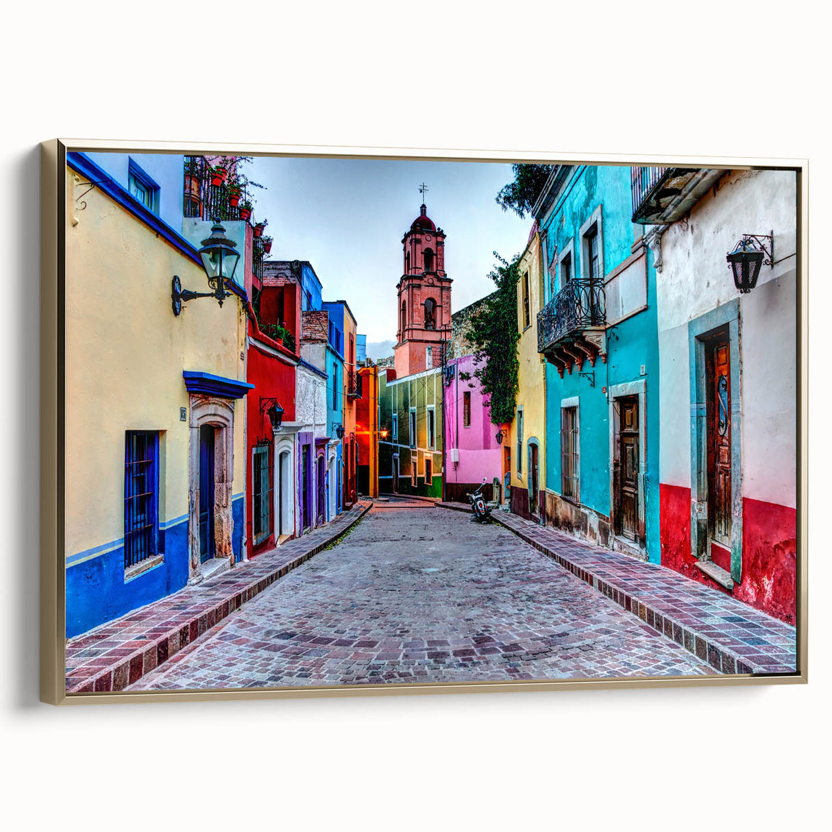 Framed canvas wall art featuring a vintage-style landscape painting of Guanajuato, Mexico in muted gold and black tones.