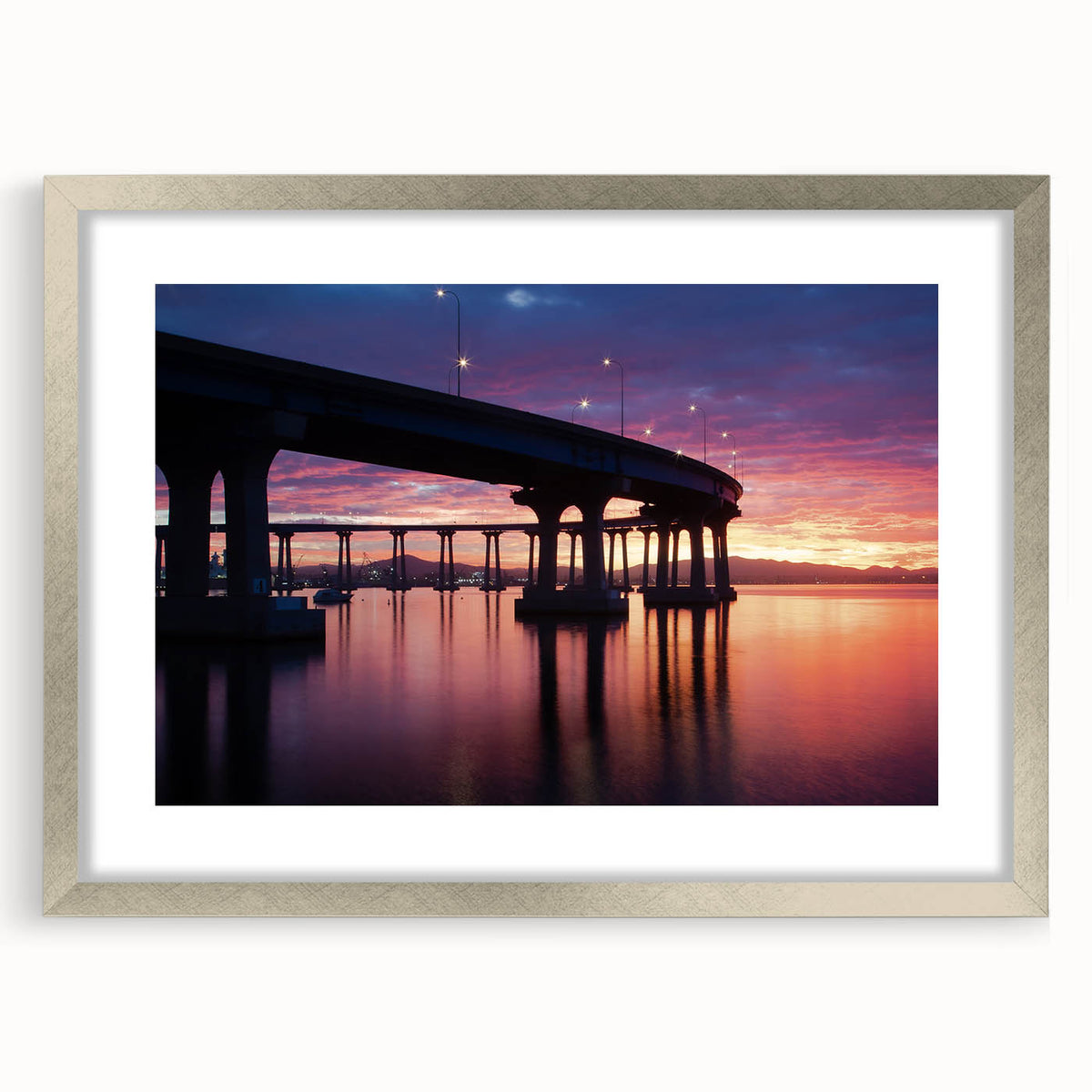 Textured abstract art print of Coronado, California in muted earth tones on a framed silver mat, suitable for bedroom decor.