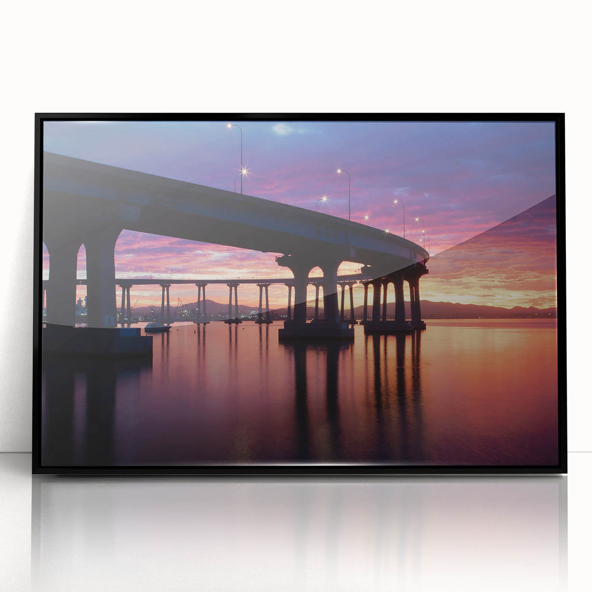 Large abstract wall art depicting the Coronado, California coastline in muted gray and blue tones, framed in black acrylic.