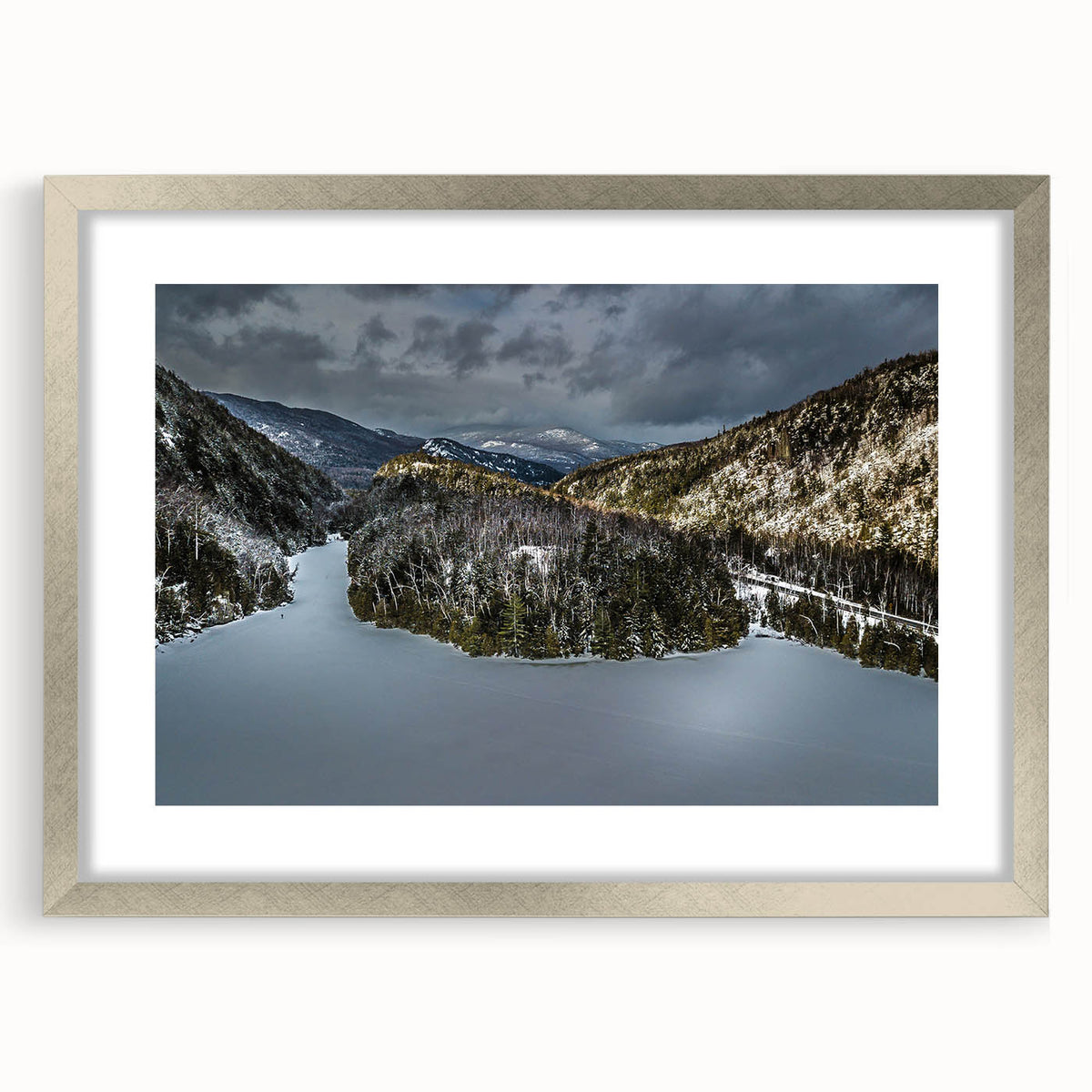 Textured art print of abstract Adirondacks scenery in silver frame, using muted earth tones, ideal for bedroom decor.