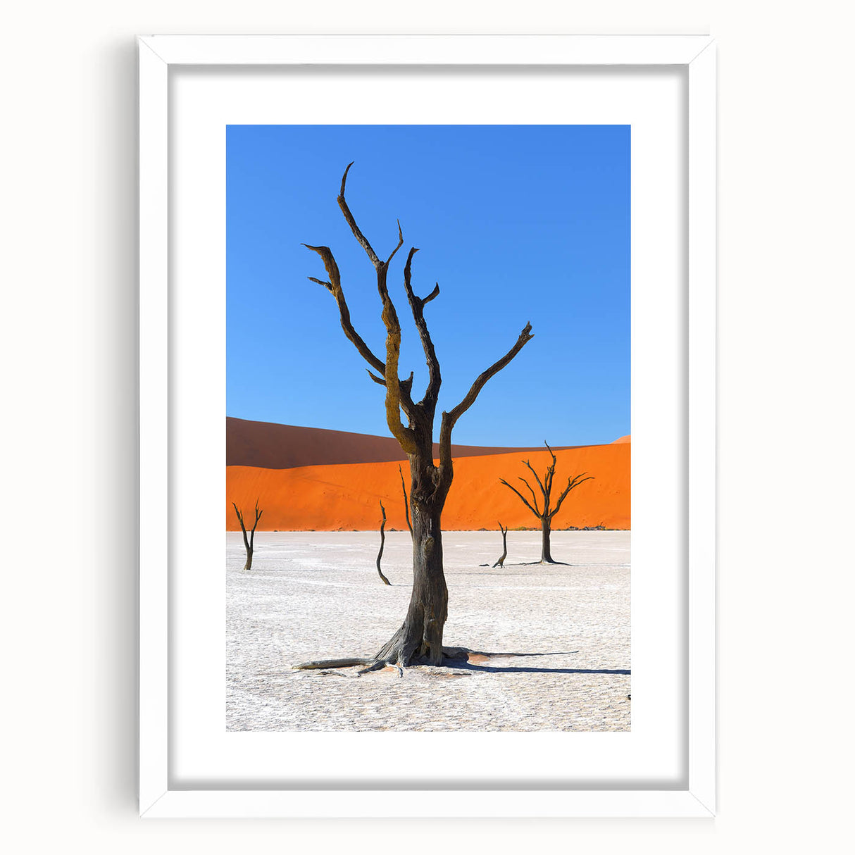 Abstract art print of Namibian landscape in muted earth tones on a framed white mat, suitable for dining room decor.