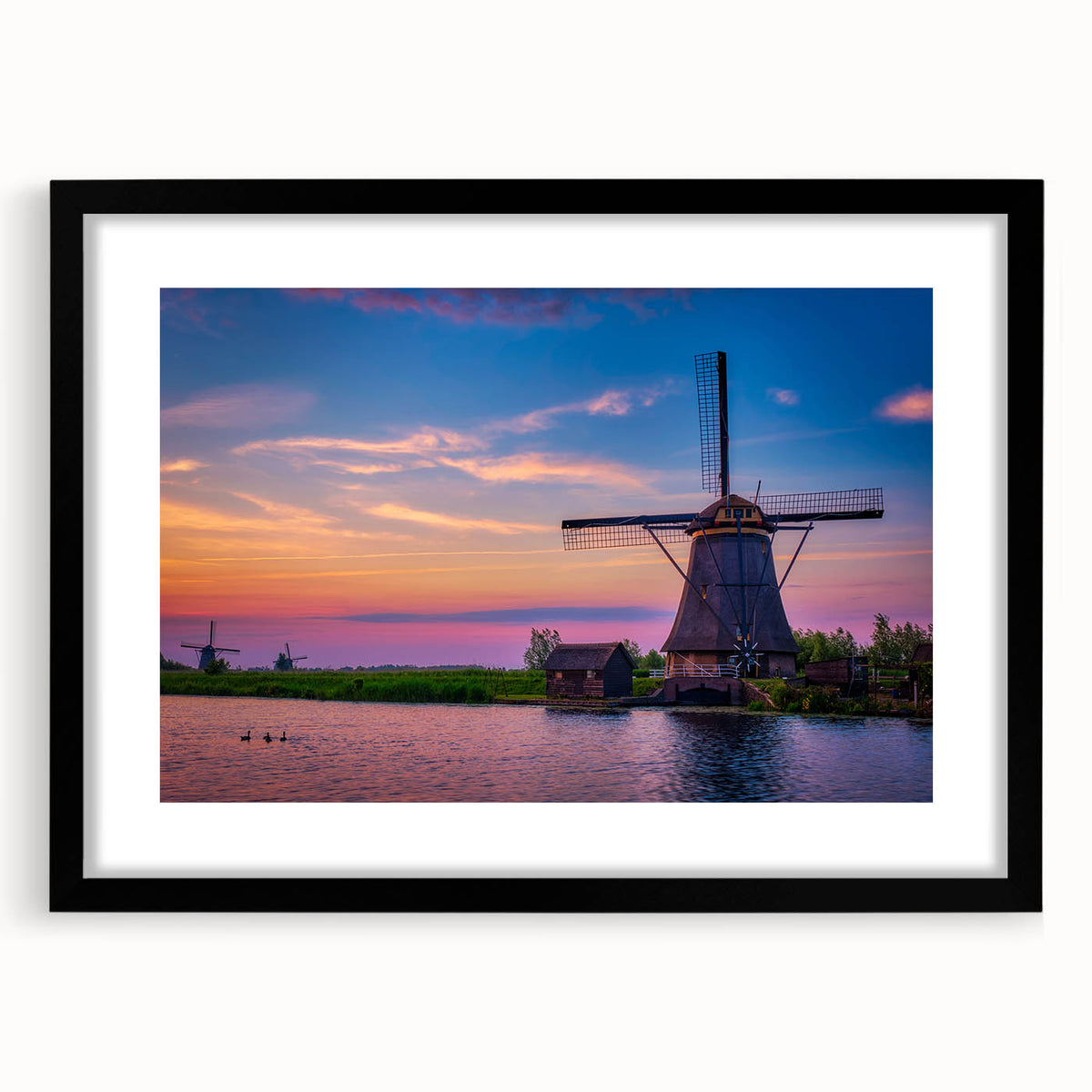 Abstract art print of a colorful European landscape, textured on a large black-framed canvas, ideal for living room decor.