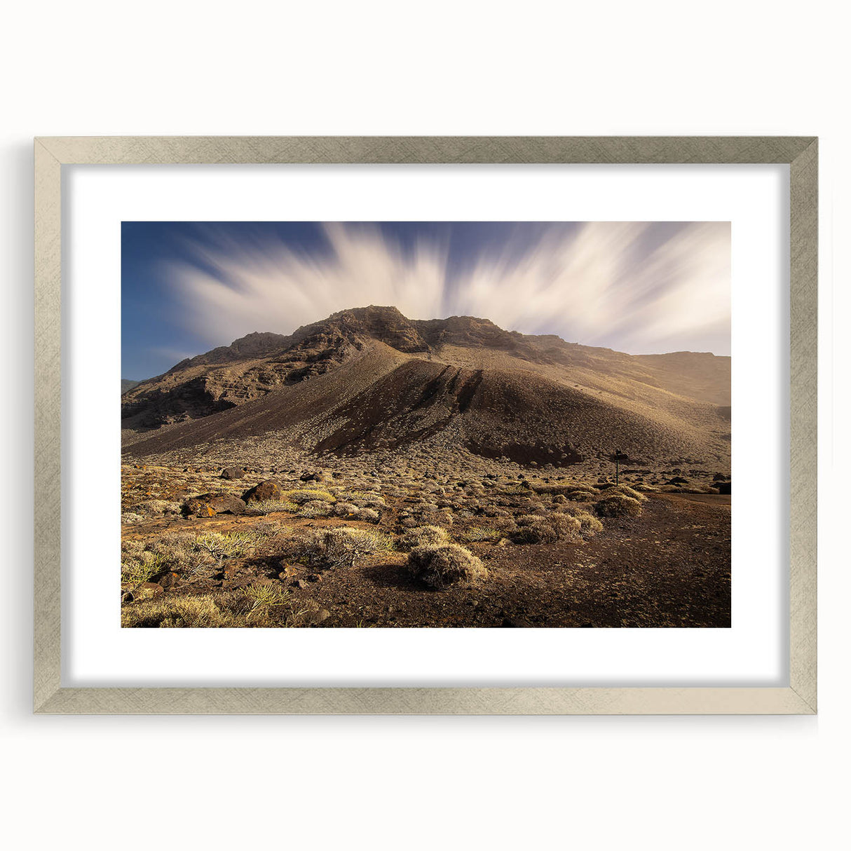 Extra large abstract art print of a textured European scenery in muted earth tones, framed in silver.