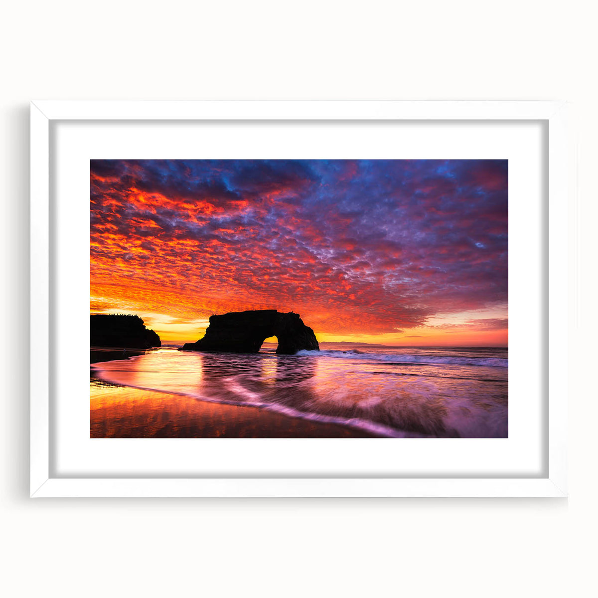 Abstract art print of Santa Cruz coastline in muted blue and green hues on a framed white mat, ideal for dining room decor.