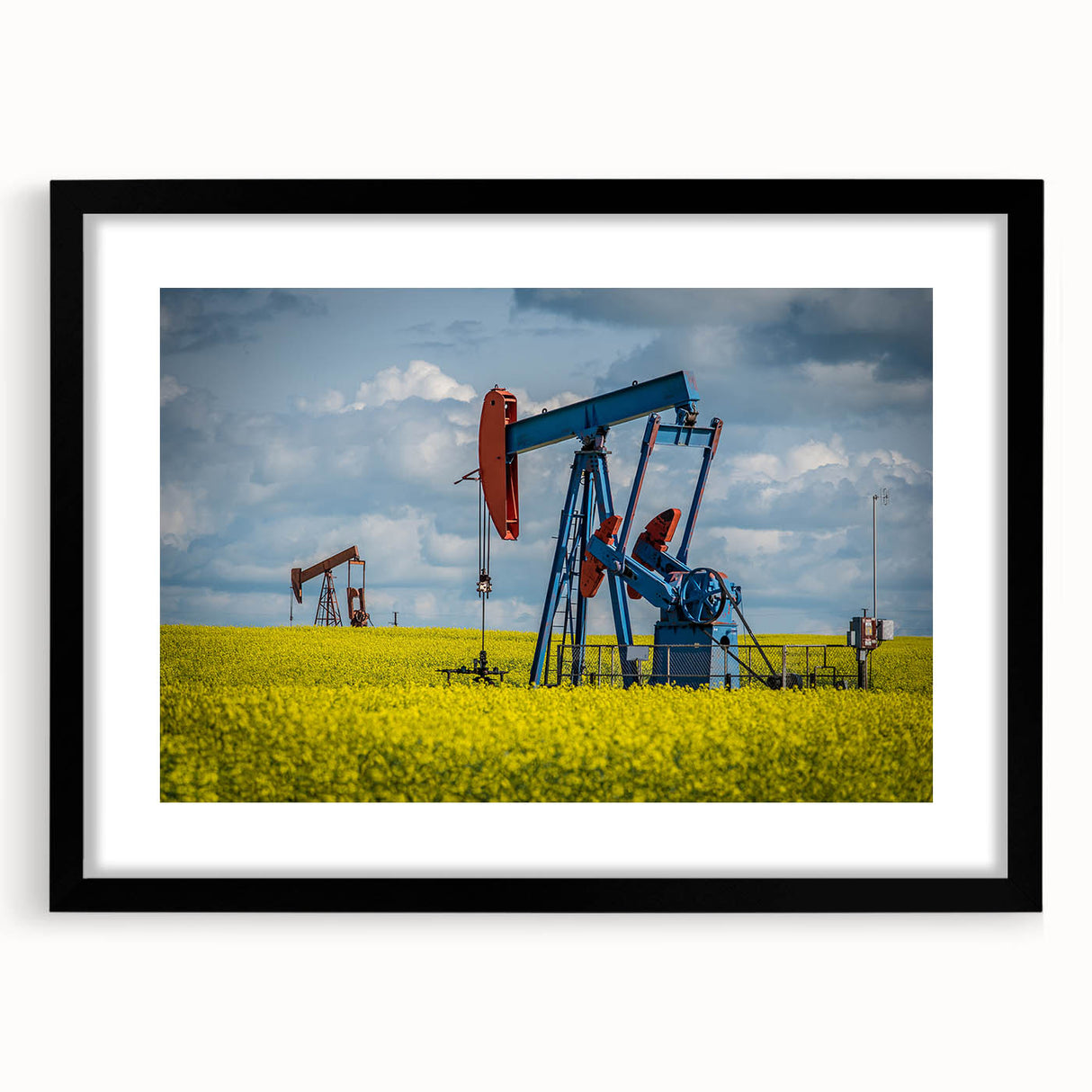 Abstract art print of colorful, textured scenery, in a black frame with mat, ideal for living room decor.