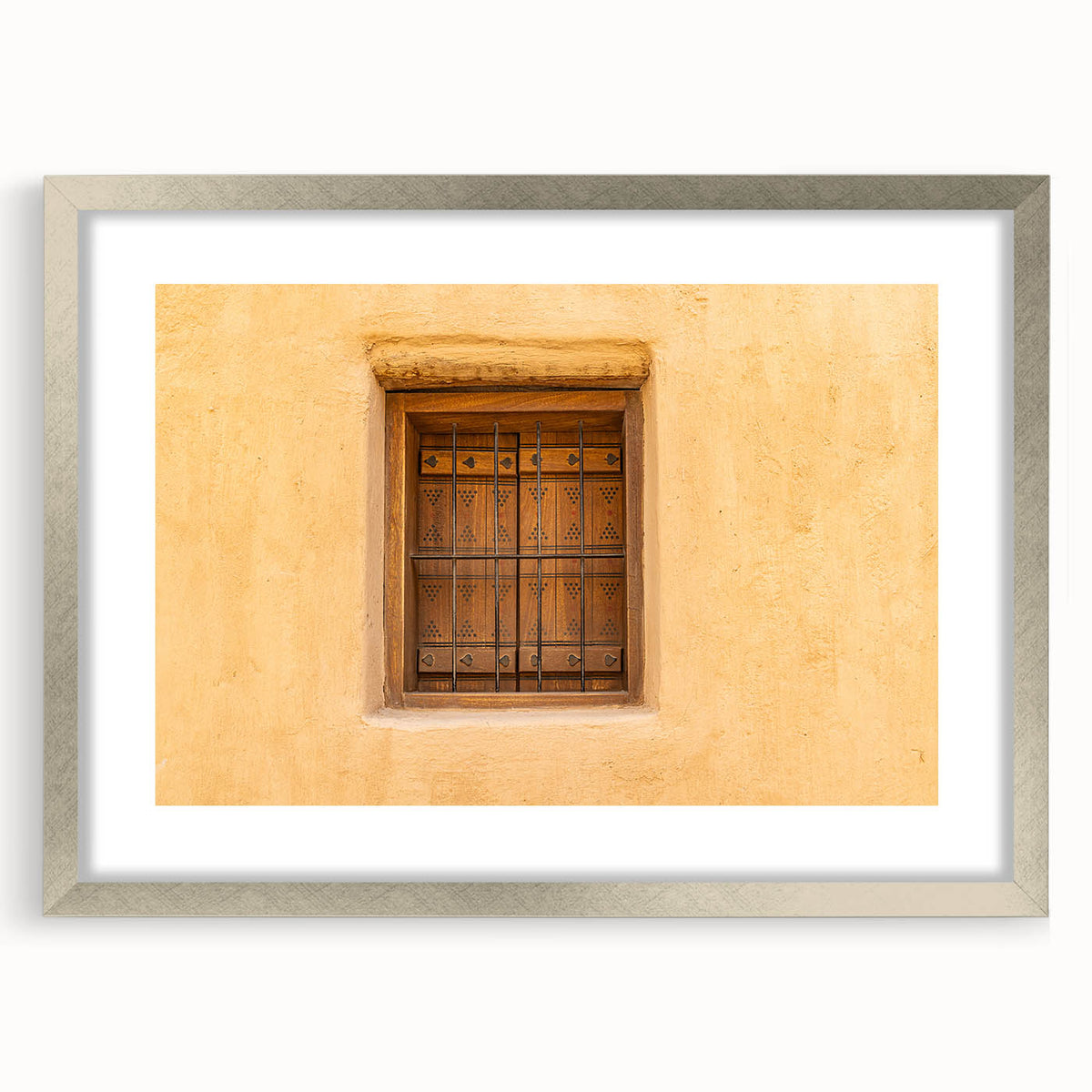 Textured art print depicting abstract scenery in muted earth tones, framed in silver, ideal for bedroom art.