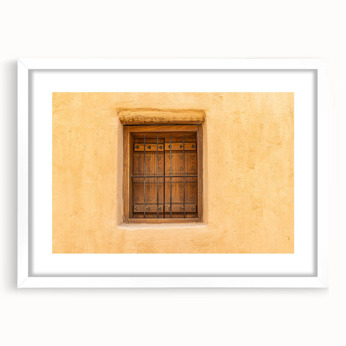 Abstract art print of a Middle Eastern desert scene in muted earth tones on a framed white mat.