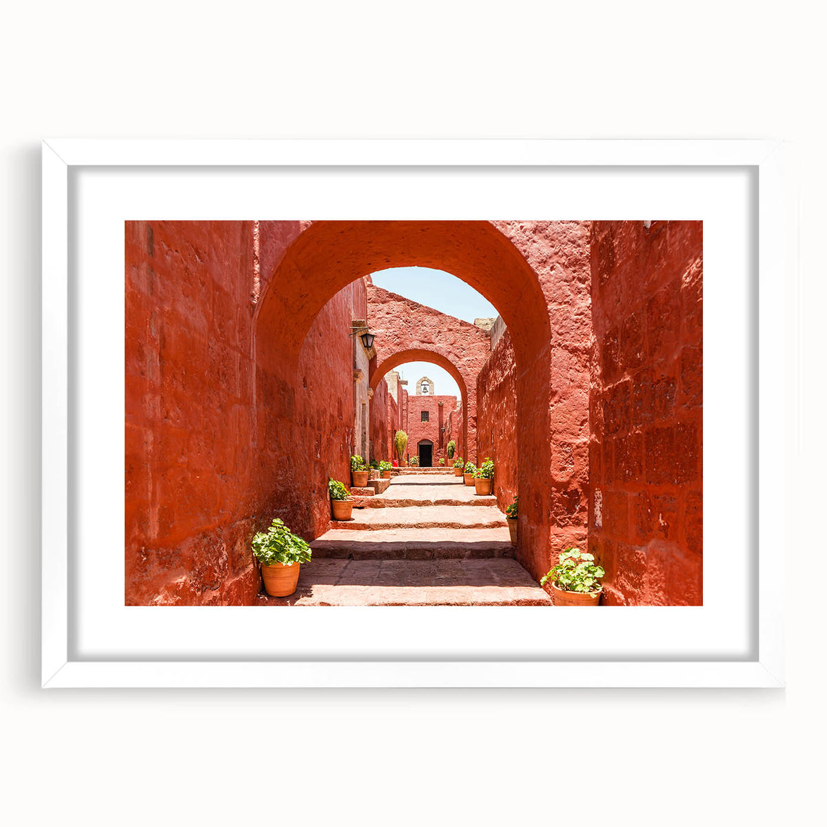 Abstract art print of Catalina, California in muted blue and green tones, displayed in a white frame with mat.