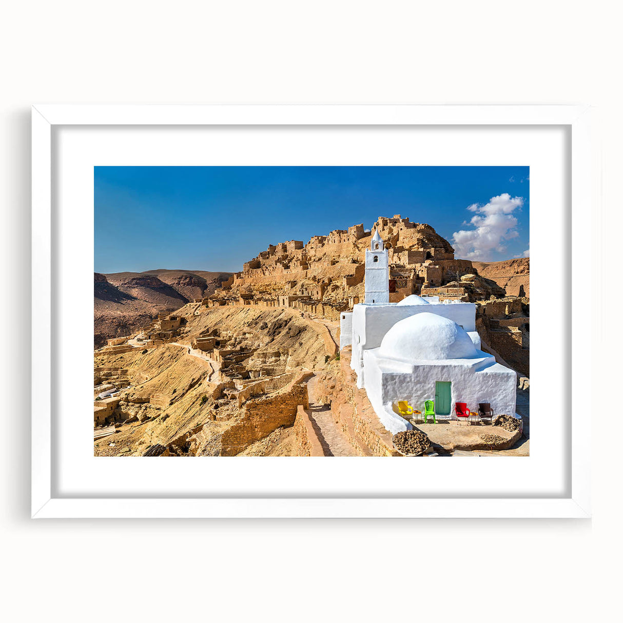 Abstract art print of a Tunisian landscape in muted earth tones on a framed white mat, suitable for dining room decor.