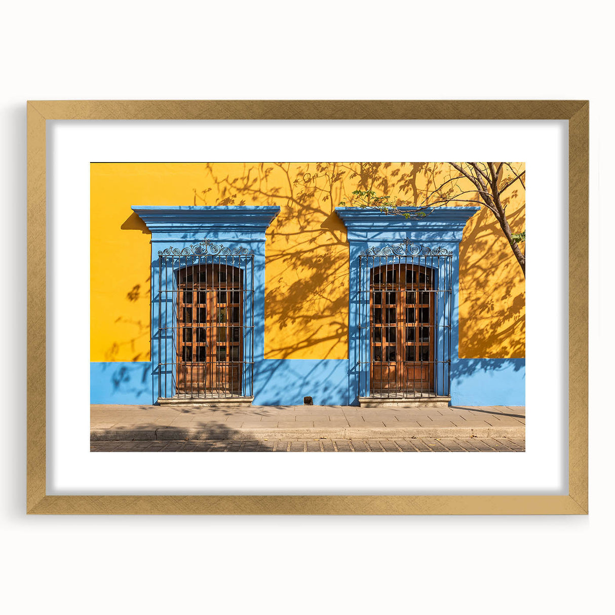 Extra large abstract art print of Oaxaca scenery, textured design in earth tones on a gold-framed canvas.