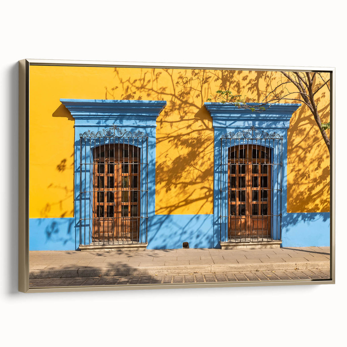 Framed canvas featuring a vintage-style landscape painting of Oaxaca, Mexico, in muted gold and black.