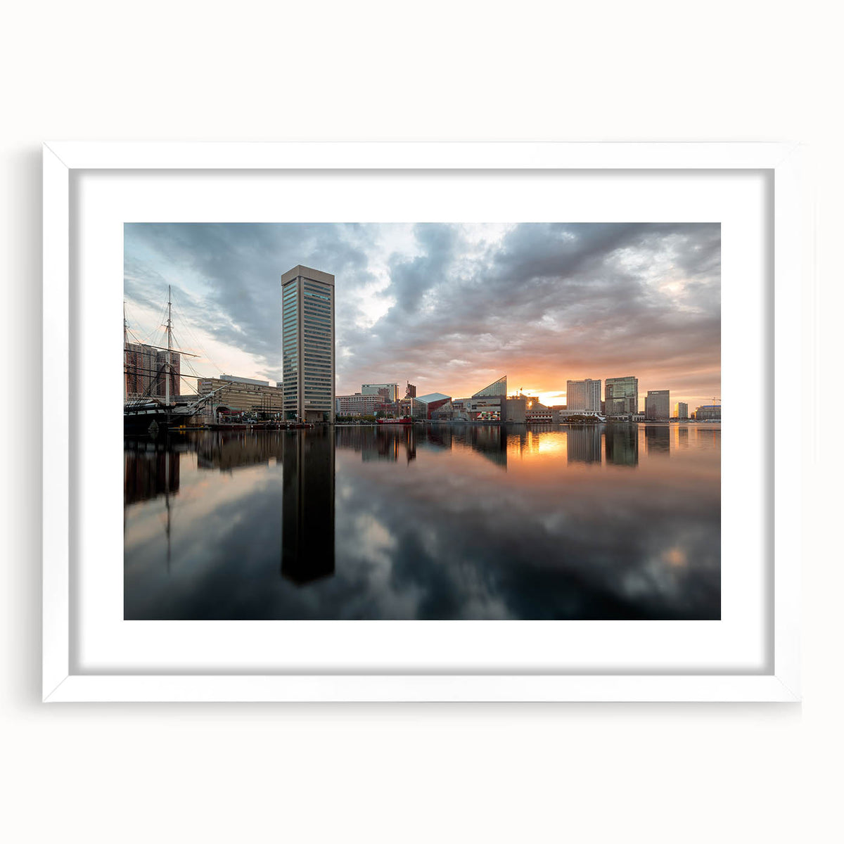 Abstract art print of Baltimore skyline in muted gray and blue tones on a framed white mat, suitable for dining room decor.