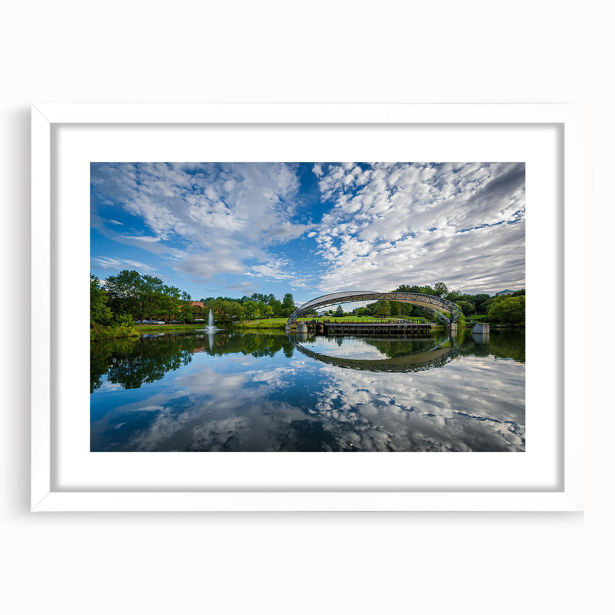 Abstract art print of Charlotte skyline in muted blue and gray tones on a framed white mat, ideal for dining room decor.