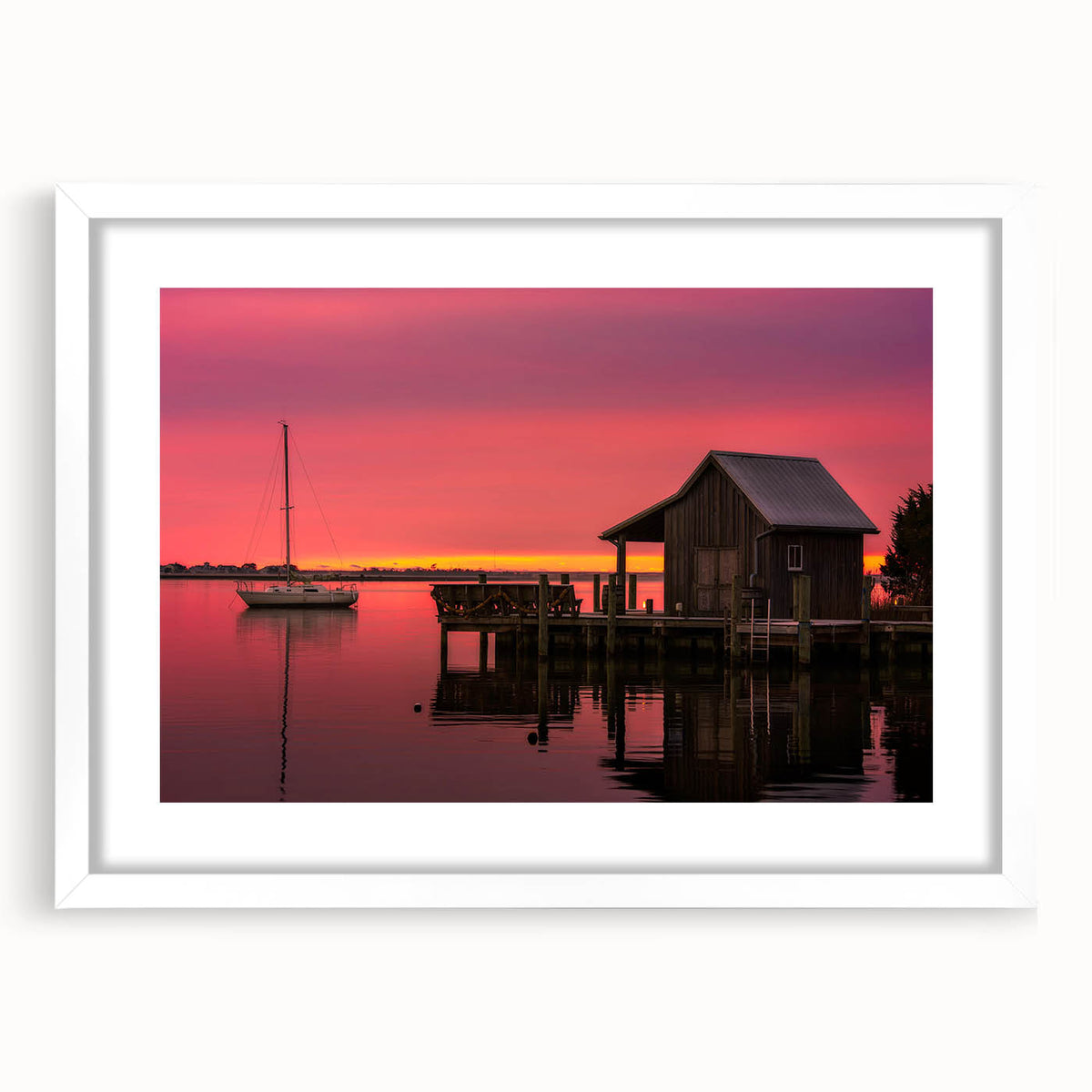 Abstract art print of the Outer Banks in muted blue and gray tones on a framed white mat, ideal for dining room decor.
