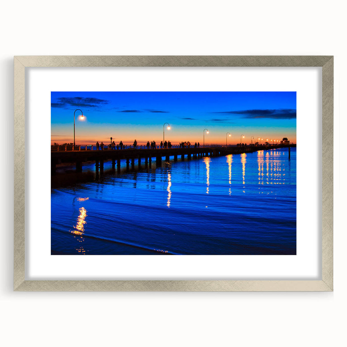 Abstract art print of Melbourne scenery in muted blue and green tones, framed in silver, suitable for dining room decor.